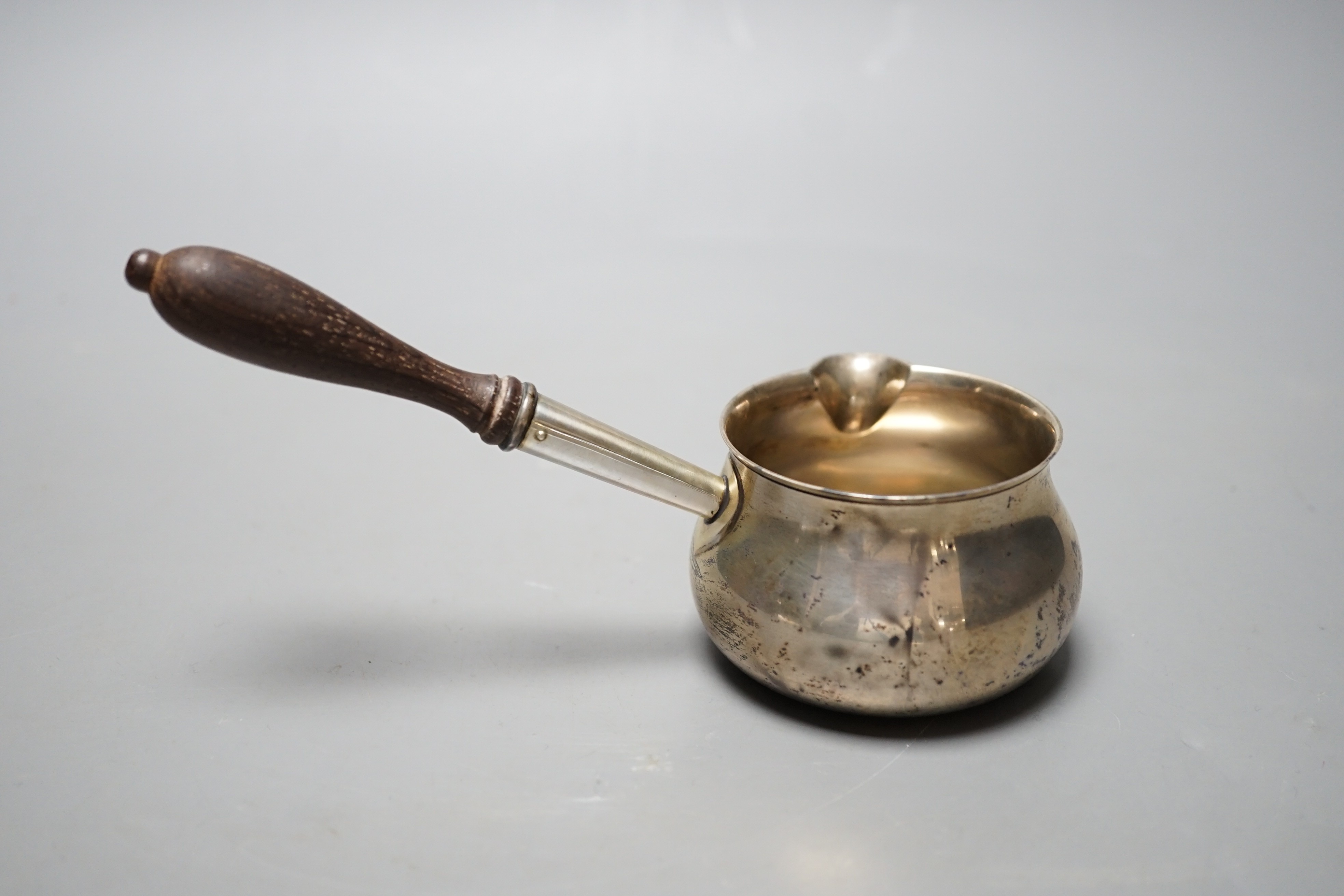 A modern silver brandy warmer, with turned wooden handle, Bryan Savage, London, 1973, 16.8cm, gross 81 grams, in an Asprey box.